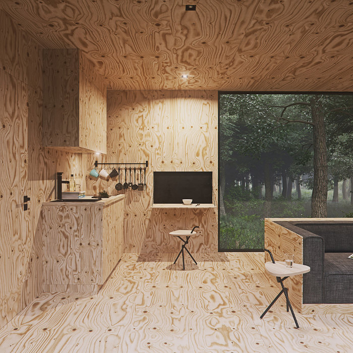 Интерьер маленького домика Tomek Michalski Cabin в лесу